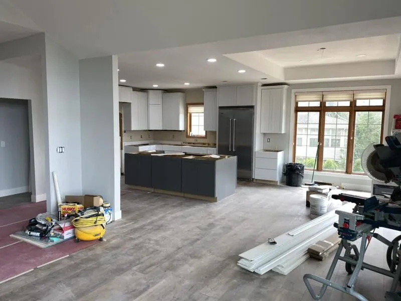 Finished modern kitchen renovation with new white and navy cabinets at same home