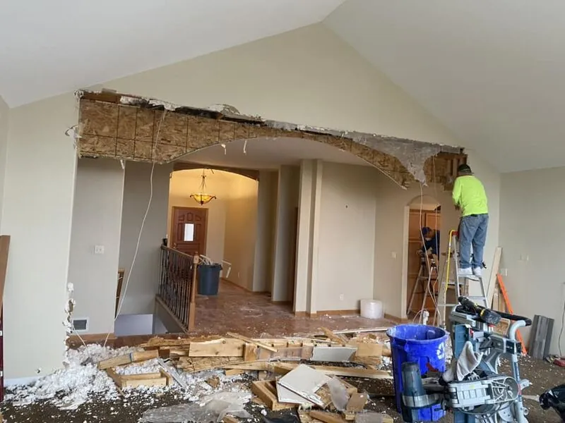 Crew removing interior walls for open concept conversion at same home