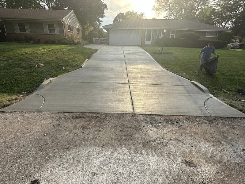 Completed new concrete driveway with broom finish at same brick ranch home