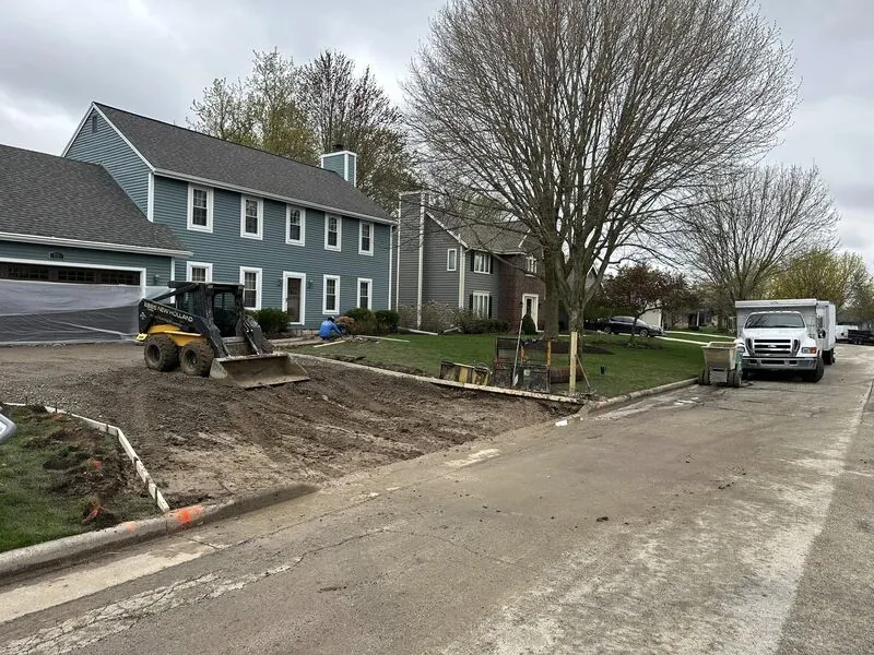Skid steer excavating old driveway at blue colonial home — Project 1 by A & L