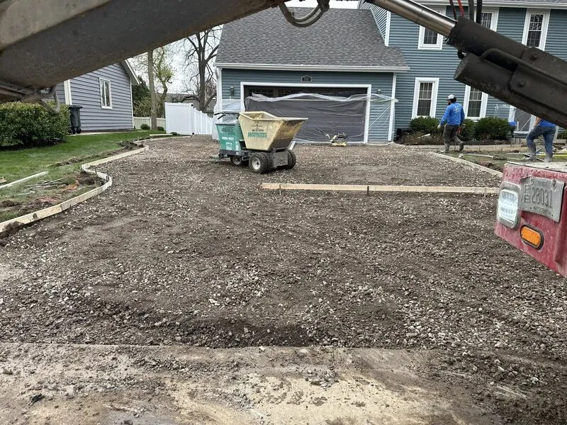 Gravel sub-base with forms and Whiteman buggy ready for pour at same blue colonial home
